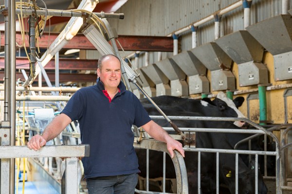John Booth in milking parlour